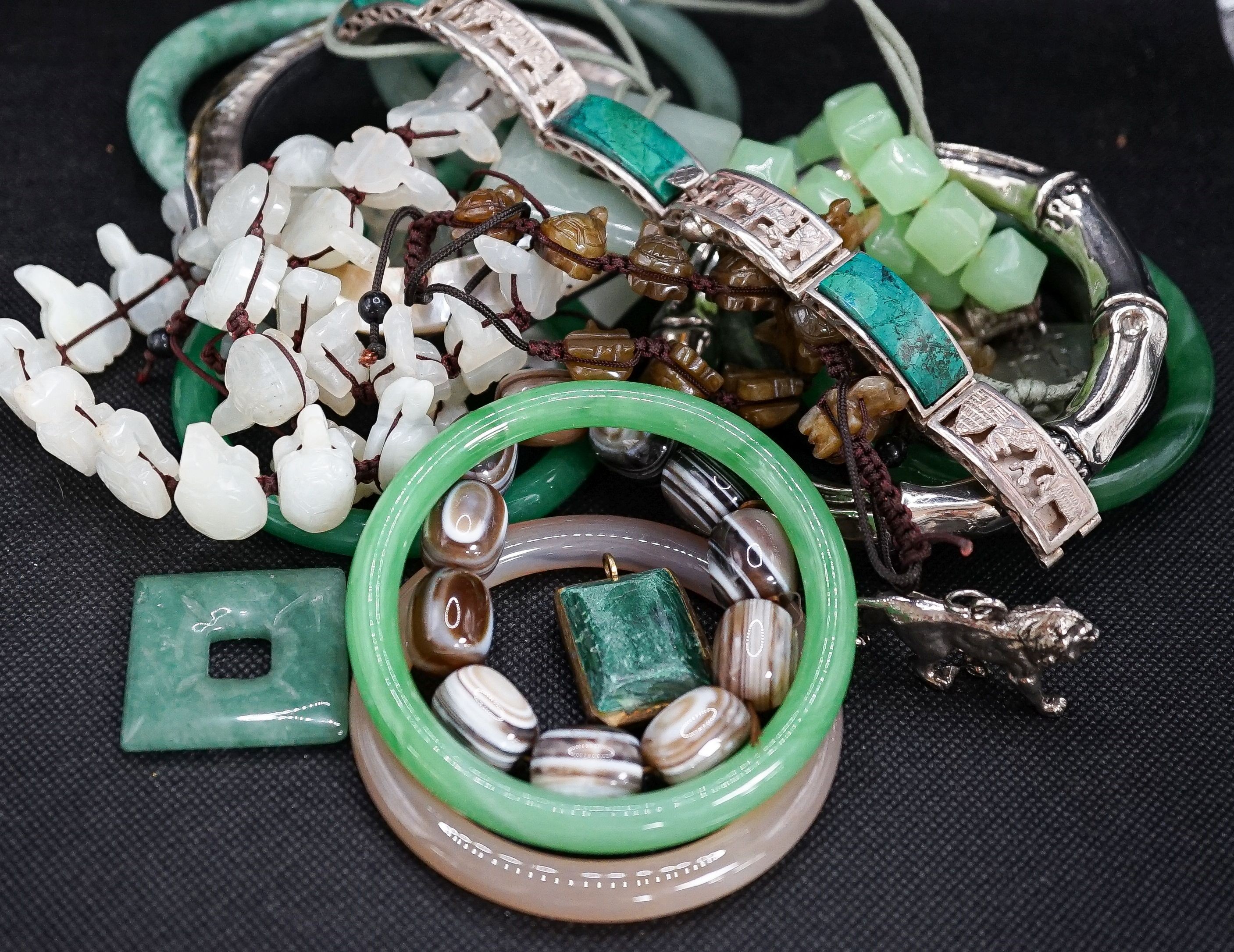 A group of bangles and necklaces including jade and agate.